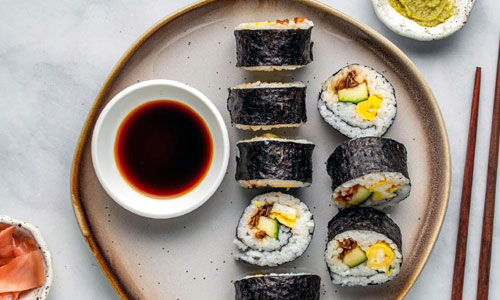 Vegetable Futomaki sushi rolls sliced on a board